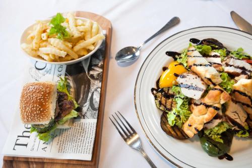 a plate of food with a sandwich and a bowl of fries at Thon Partner Hotel Narvik in Narvik