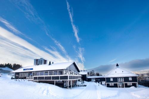 a large building with snow on the ground at Thon Partner Hotel Narvik in Narvik
