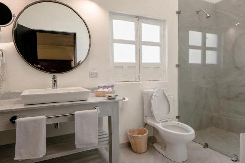 a bathroom with a toilet a sink and a mirror at Hotel La Morada in San Miguel de Allende