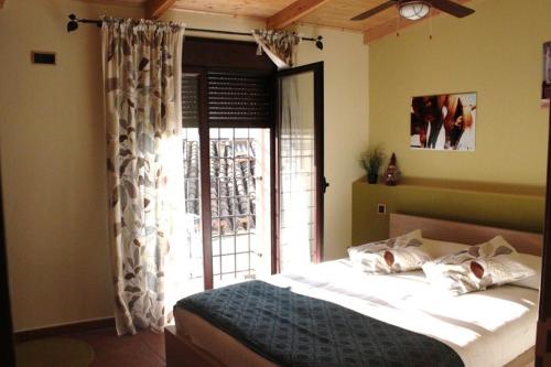 a bedroom with a bed in front of a window at Casa el Aljibe in Lanaja