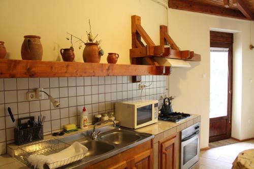 a kitchen with a sink and a microwave at Vargapartman in Szeged