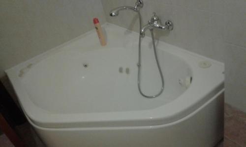 a bath tub with a shower head on top of it at Le Palme in Chieti