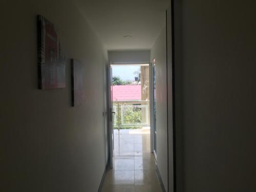 an empty hallway with a door and a window at Apartamentos Martinez in San Andrés