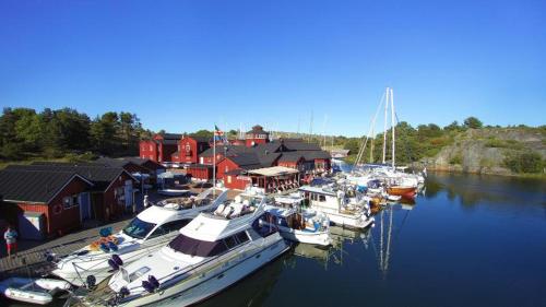 a group of boats docked in a harbor with houses at Brudhäll Hotel & Restaurant in Kökar
