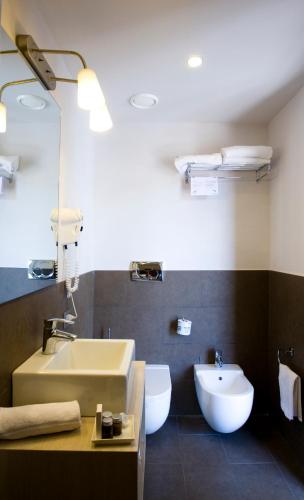 a bathroom with a sink and a toilet at Il Piccolo Giardino GH ***Superior in Taormina