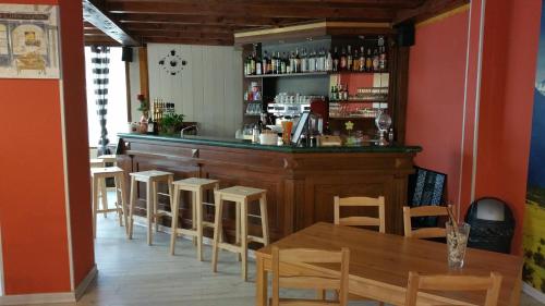 a bar with chairs and a table in a restaurant at Atmosphere Hotel in Les Deux Alpes