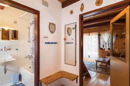 a bathroom with a tub and a toilet and a sink at Holiday Home Kuća Ulaga in Ravna Gora