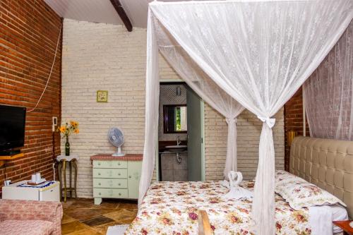 sypialnia z łóżkiem z baldachimem w obiekcie La Dolce Vita w mieście Mulungu