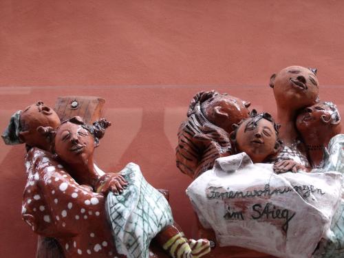 a group of statues of people holding a bag at Apartmenthaus im Stieg in Quedlinburg