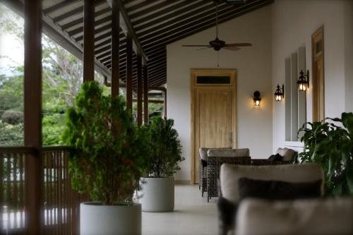 a living room with potted plants and a ceiling at Paseo Suites El Valle, Luxury Apartments in Valle de Anton