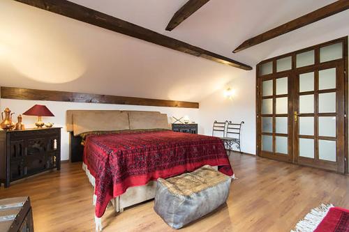 a bedroom with a large bed with a red blanket at Old Town Apartment in Sarajevo