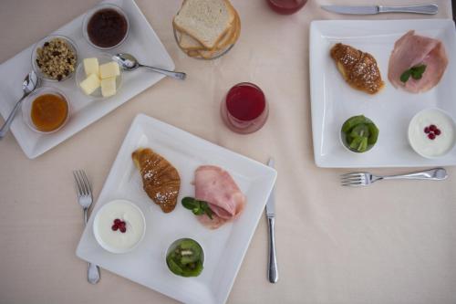 a white table with plates of food on it at Locanda di Pietracupa in Tavarnelle in Val di Pesa