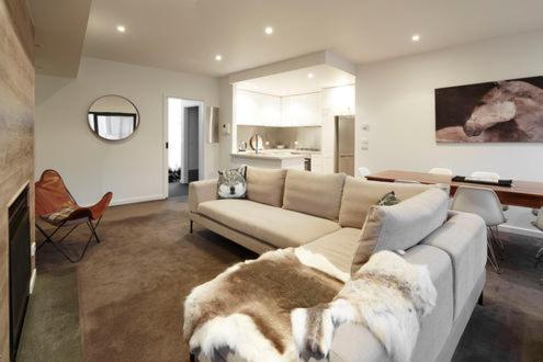 a living room with a couch and a dog laying on it at Alto Villa 304 in Mount Buller