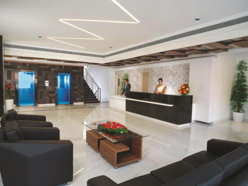 a lobby with couches and a table in a building at The Central Residency in Trivandrum