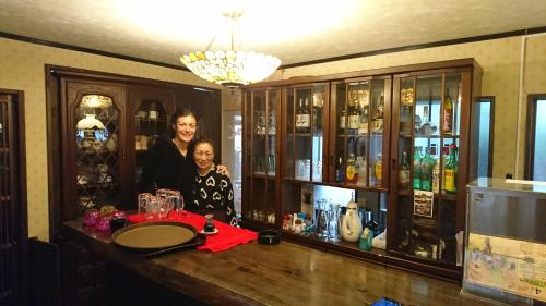 a man and a woman standing behind a bar at Live Cafe Hisui no Umi in Itoigawa