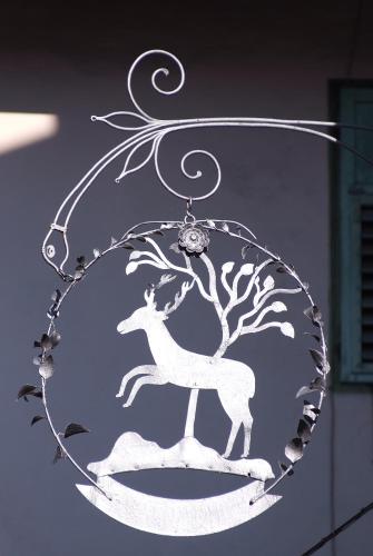 a christmas ornament of a deer in a tree at Hotel Al Cervo in Tesero