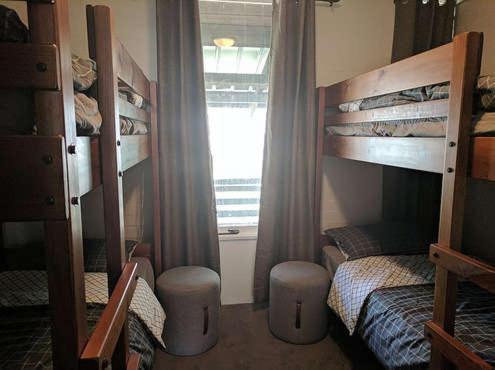 a bedroom with two bunk beds and a window at Hima 5 in Mount Buller