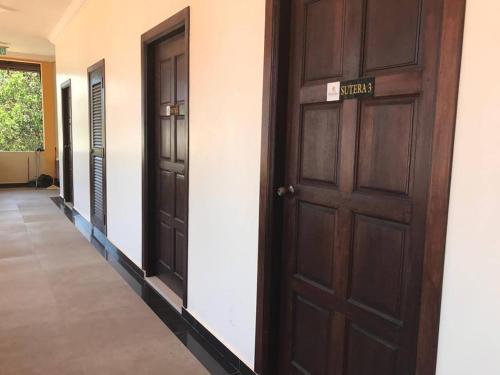 a row of doors in a hallway of a building at Teluk Lipat Seaview Inn in Dungun