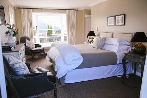 a bedroom with a large bed and a window at Ngamihi Lodge in Rotorua