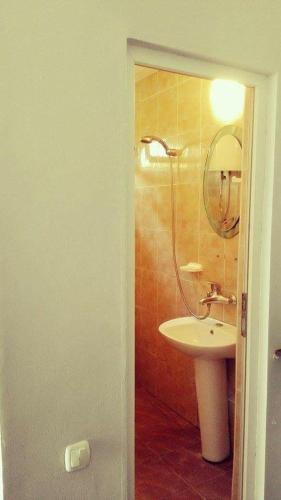 a bathroom with a sink and a mirror at Villa Vachnadze in Shekvetili