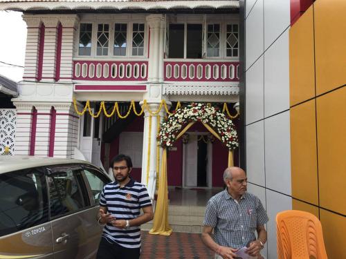 two men are standing in front of a building at Palm Rivera Kochi in Cochin