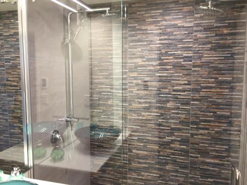 a shower with a glass door in a bathroom at Distinctive Alpine Meadows in Queenstown