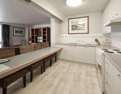 a large white kitchen with a long counter top at Twin Towers 502A in Mount Buller