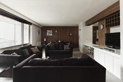 a living room with a couch and a tv at Twin Towers 603b in Mount Buller