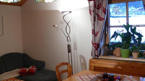 a room with a table and a lamp and a window at Apartments Seegartl in Fuschl am See