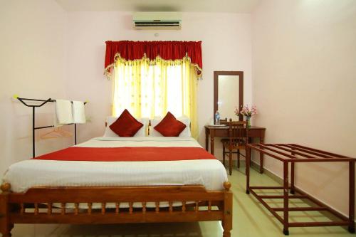a bedroom with a large bed and a window at Palakal Residency in Cochin