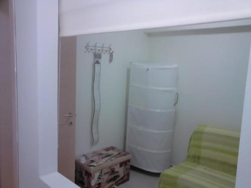 a bathroom with a shower and a refrigerator at Luxury apartment by the beach in Néa Péramos