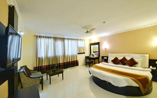 a bedroom with a large bed in a room at Hotel City Heart Premium in Chandīgarh