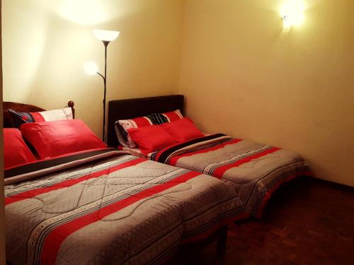 two beds sitting next to each other in a room at D Savoy Famosa Condo in Melaka