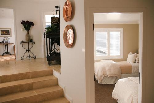 a bedroom with stairs leading to a bed and a window at Ngamihi Lodge in Rotorua