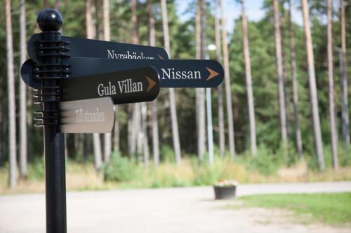 a sign in a park with street signs on it at Tylebäck Hotell & Konferens, BW Signature Collection in Halmstad