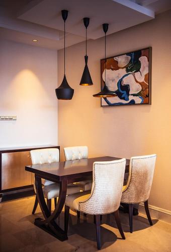 a dining room with a table and chairs at Wyndham Grand Xi'an Residence in Xi'an