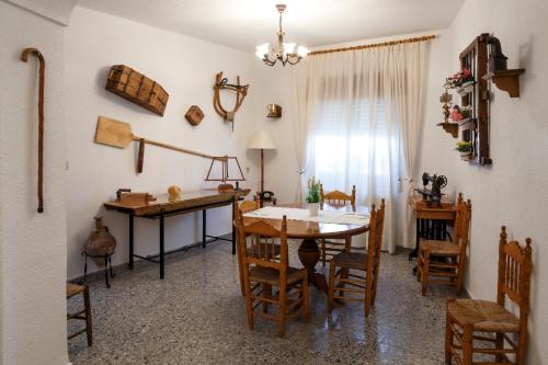 a kitchen and dining room with a table and chairs at Cueva El Murallon Benamaurel in Benamaurel