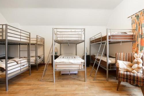 a room with four bunk beds and a chair at Slemish Barn Hostel in Ballymena