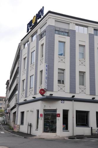 a white building with a sign on top of it at Cit'Hotel Europeen in Angoulême