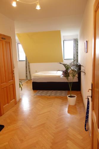 a bedroom with a bed and a potted plant at Weingut Primus Südsteiermark in Spielfeld