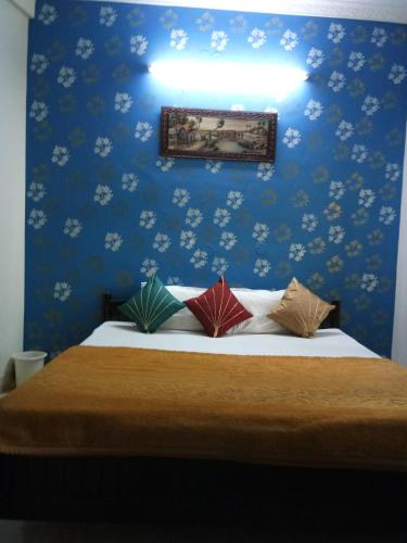 a blue bedroom with a bed with four pillows at Haveli Taragarh Palace in Būndi