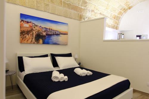 a bedroom with a large bed with shoes on it at Il Viandante in Polignano a Mare