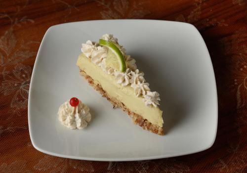 a slice of lime cheesecake on a white plate at Le camere di Sementis in Pietrasanta