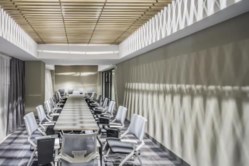 a long conference room with a long table and chairs at Almaty Hotel in Almaty
