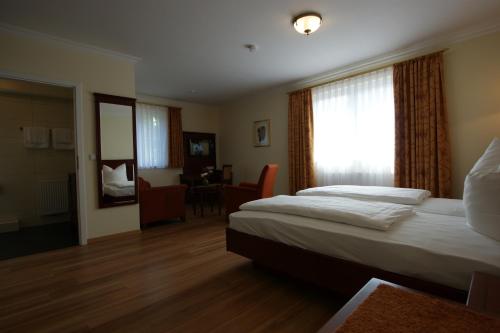 a hotel room with two beds and a window at Waldcafé Hotel Restaurant in Baden-Baden