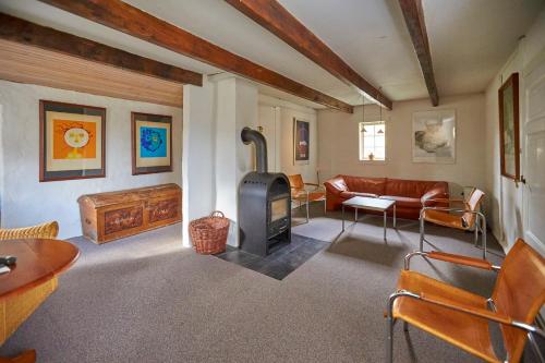 a living room with a couch and a wood stove at Møllegade 1 Holiday House in Nordborg