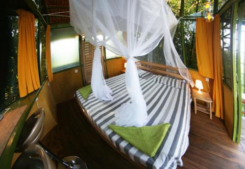 a bed in the back of a boat with curtains at Yellow Haven Lodge in Kampala