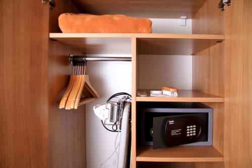 a cupboard with a microwave and a small refrigerator at Akcent hotel in Prague