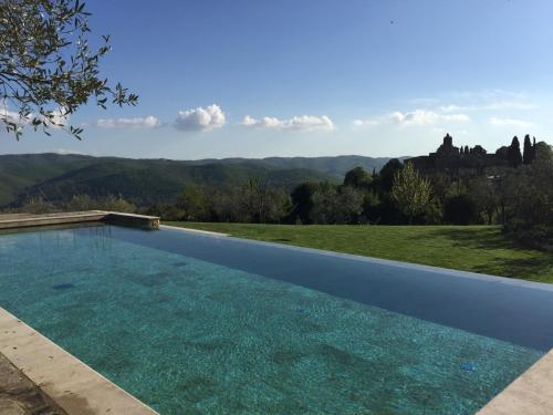 a swimming pool with a view of a mountain at Villa Le Barone in Panzano