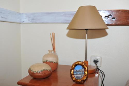 a table with a lamp and a mirror on a table at 16 Porto Santo Apartments in Porto Santo